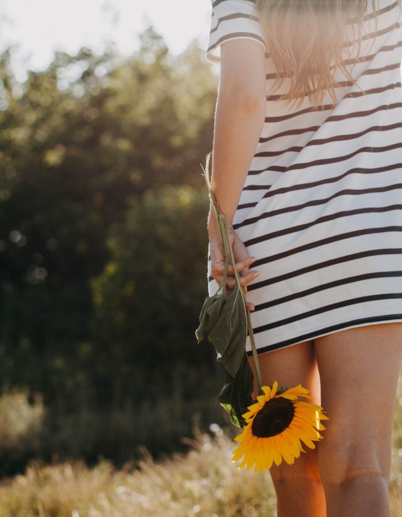 Girl holding a sunflower