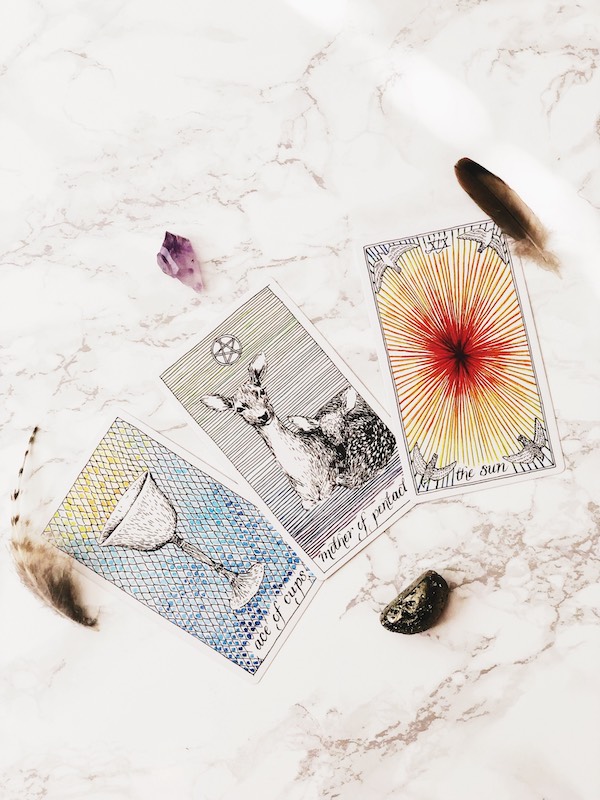 Tarot cards, crystals and feathers