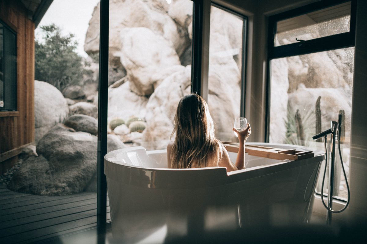 A woman lounging in a bathtub on a wellness retreat