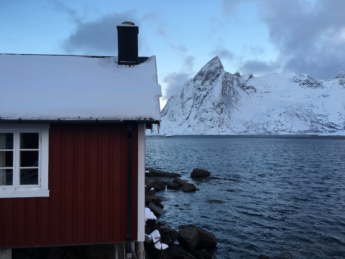 red house overlooking the icy fjord